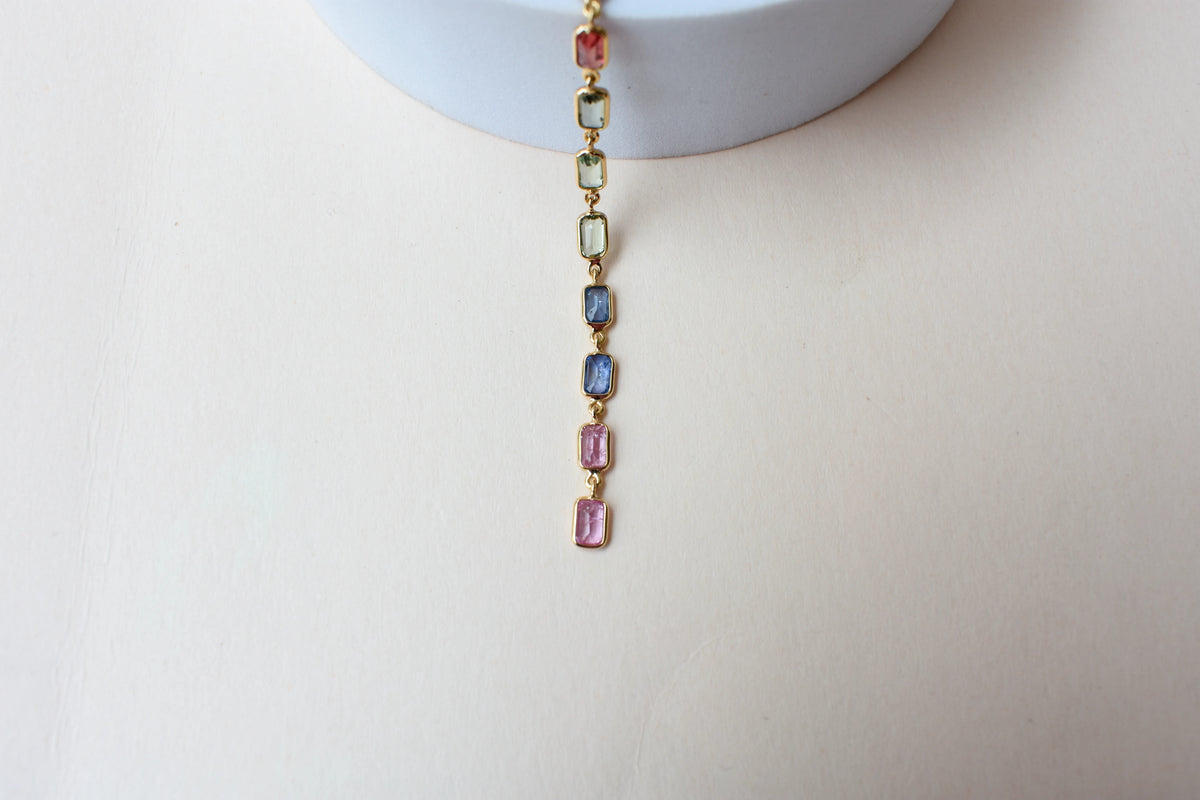 18K gold pendant with a graduated line of bezel-set multicolor sapphires