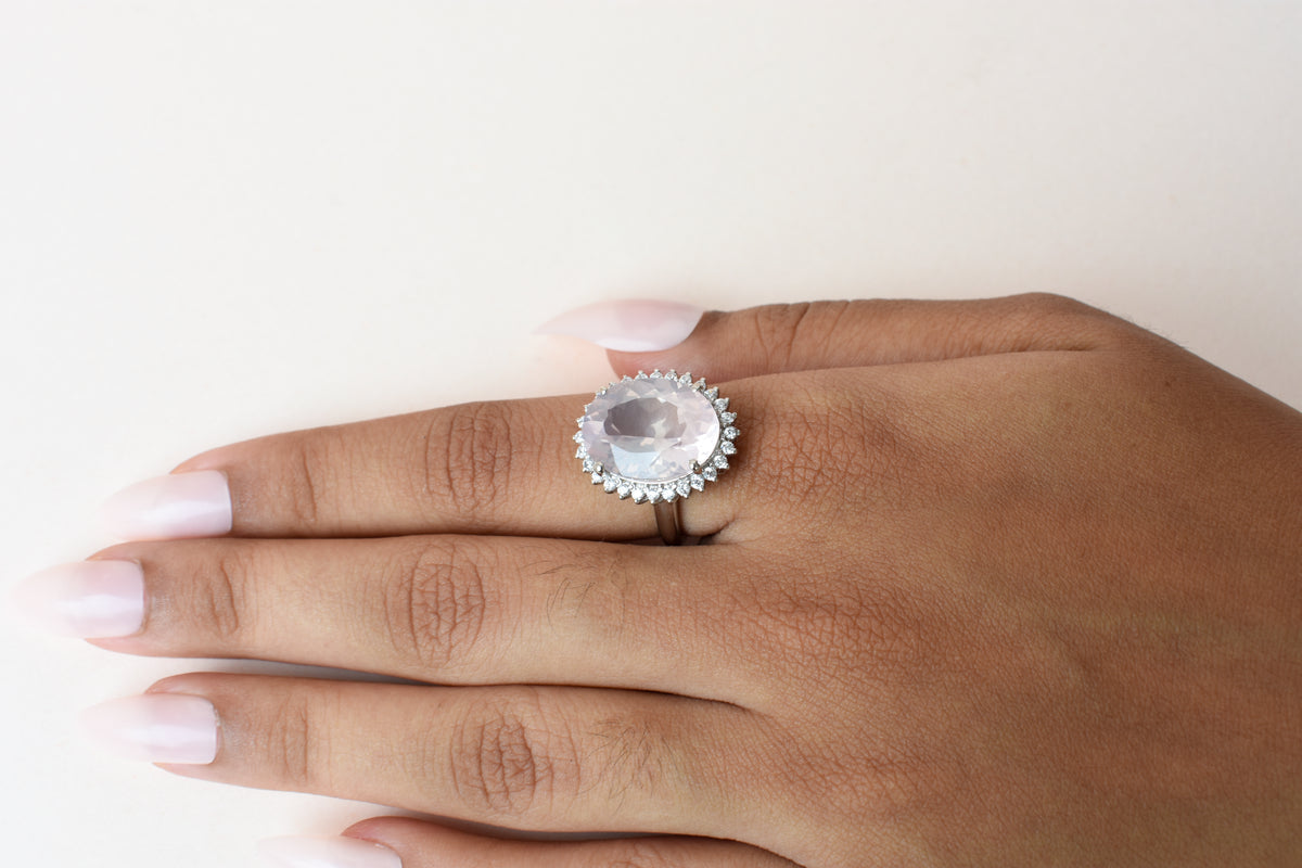 Oval rose quartz halo ring in 925 silver with cubic zirconia accents