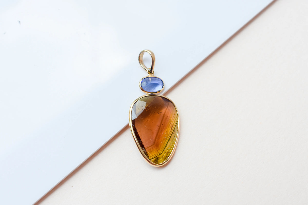 18K gold pendant with tourmaline slice and tanzanite accent