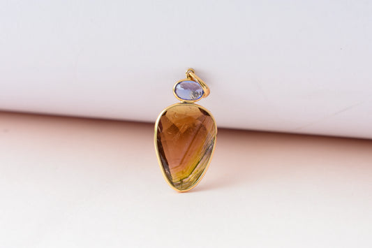 18K gold pendant with tourmaline slice and tanzanite accent