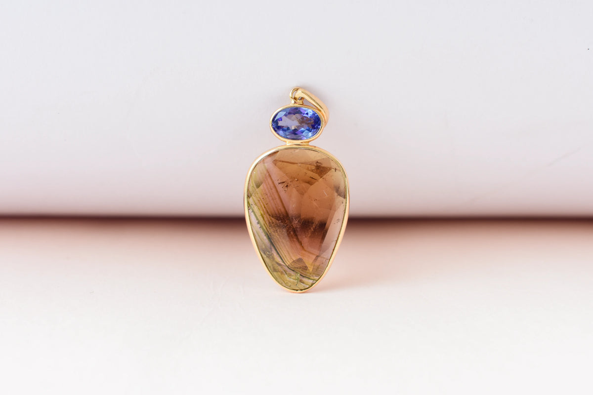 18K gold pendant with tourmaline slice and tanzanite accent