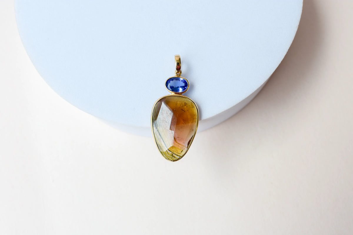 18K gold pendant with tourmaline slice and tanzanite accent