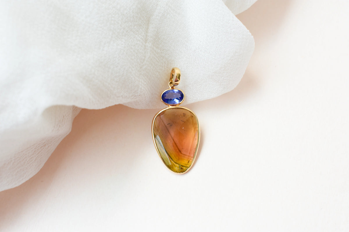 18K gold pendant with tourmaline slice and tanzanite accent