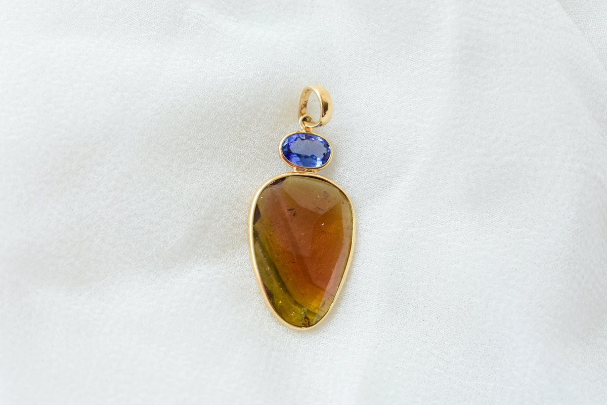 18K gold pendant with tourmaline slice and tanzanite accent