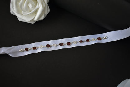 Garnet station bracelet with bezel-set stones and filigree flower links in 925 silver