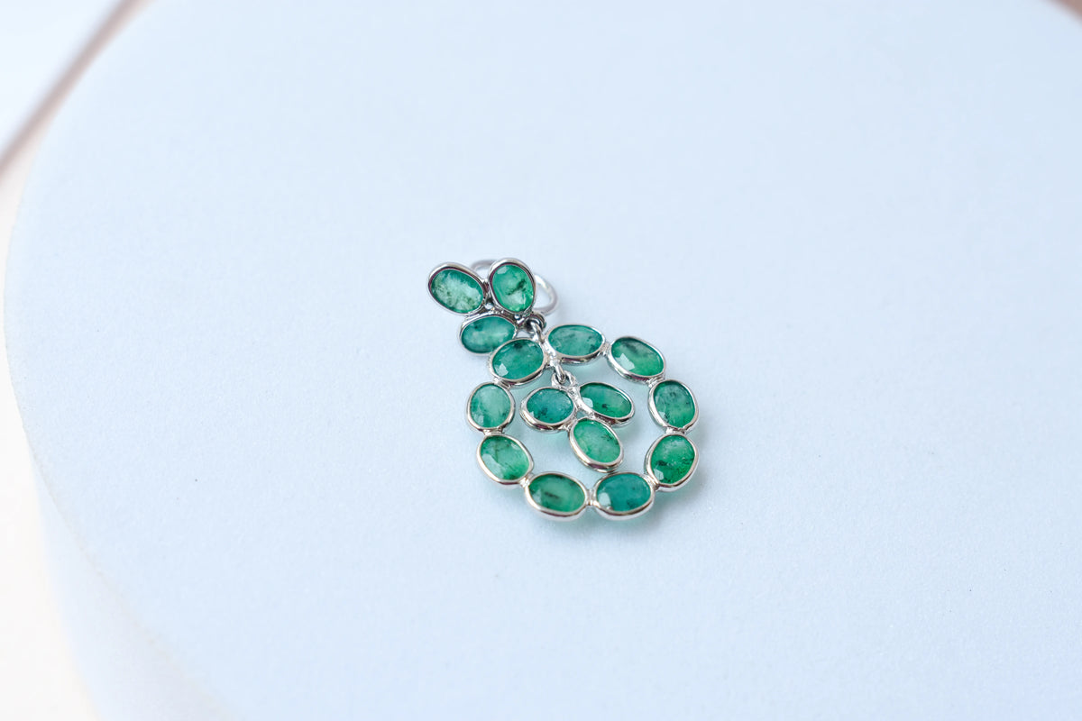 14K gold pendant with a wreath of bezel-set emeralds