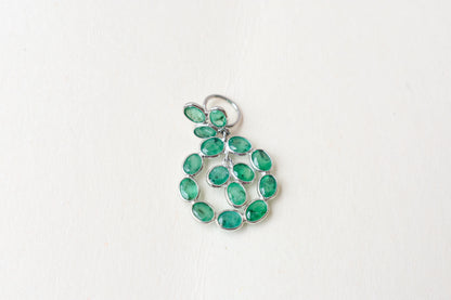 14K gold pendant with a wreath of bezel-set emeralds