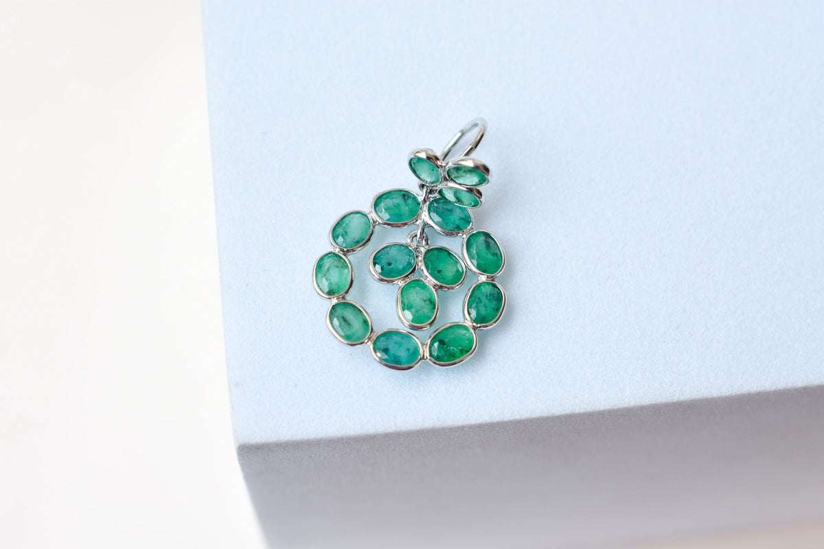 14K gold pendant with a wreath of bezel-set emeralds