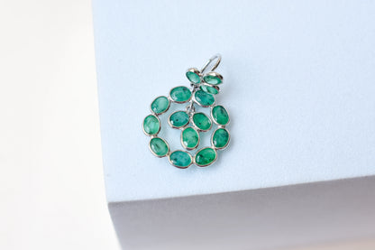 14K gold pendant with a wreath of bezel-set emeralds