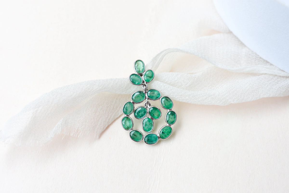 14K gold pendant with a wreath of bezel-set emeralds