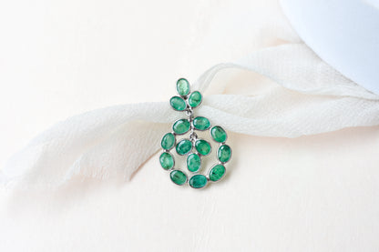 14K gold pendant with a wreath of bezel-set emeralds