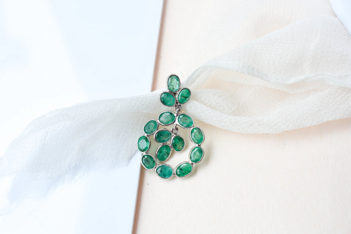 14K gold pendant with a wreath of bezel-set emeralds
