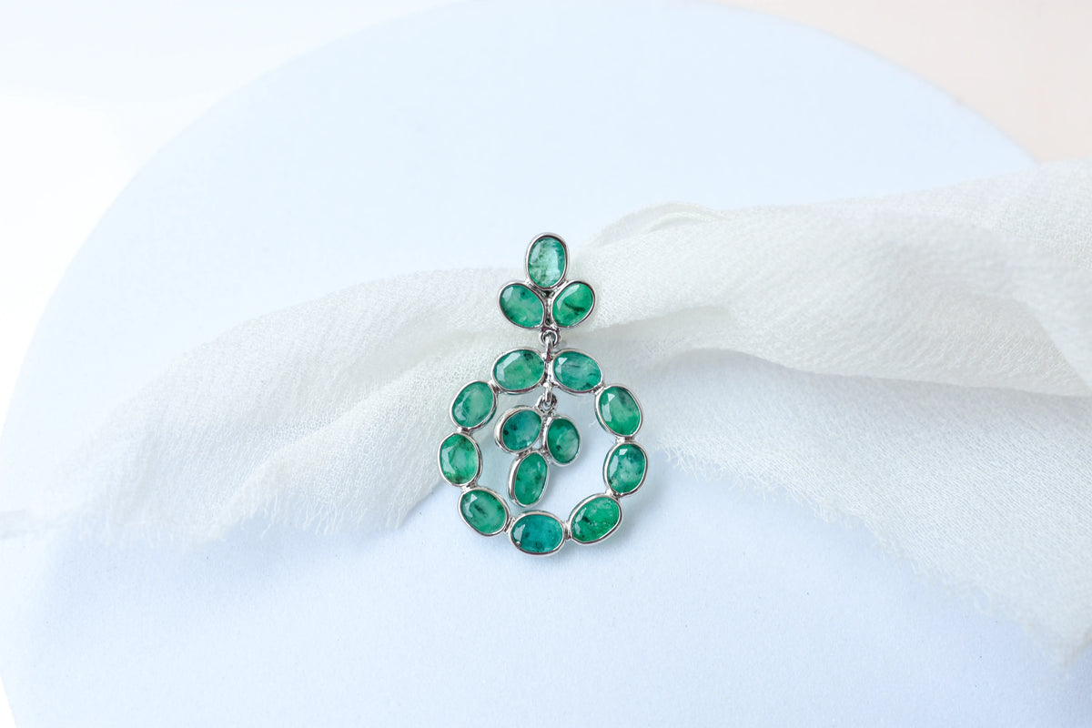14K gold pendant with a wreath of bezel-set emeralds
