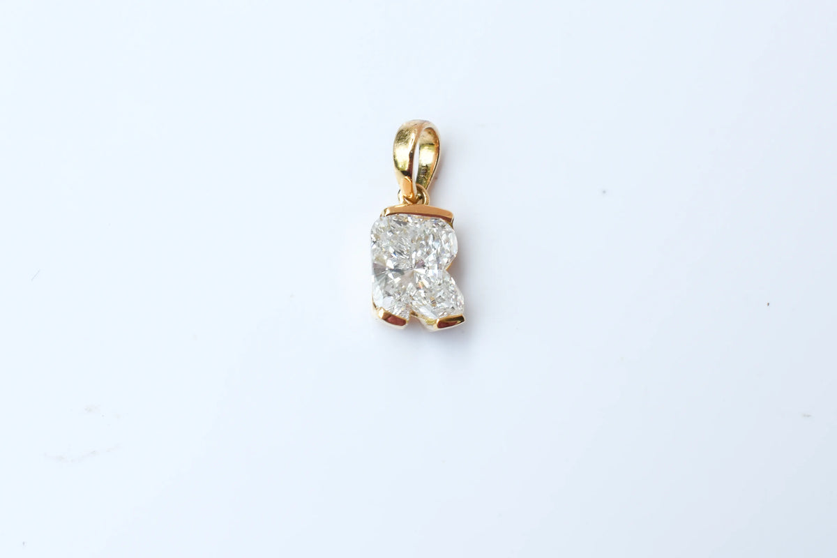 18K gold pendant with lab-grown diamond cut into the letter R