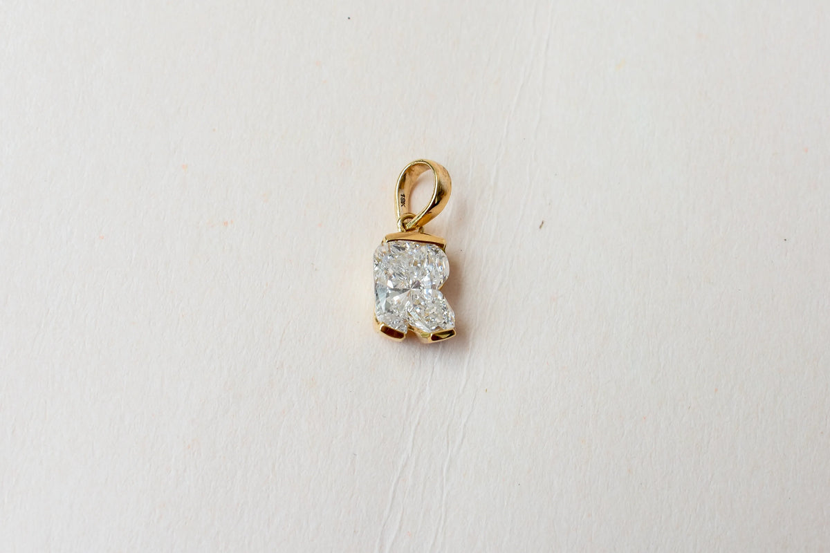 18K gold pendant with lab-grown diamond cut into the letter R