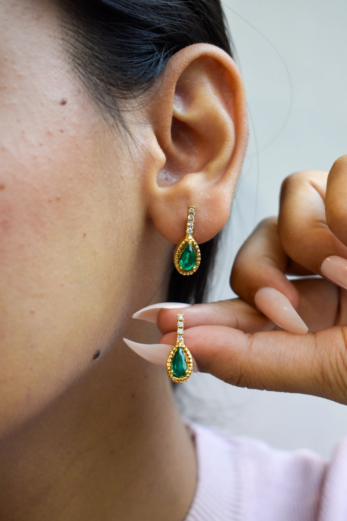 18K gold stud earrings with emerald and diamond accents
