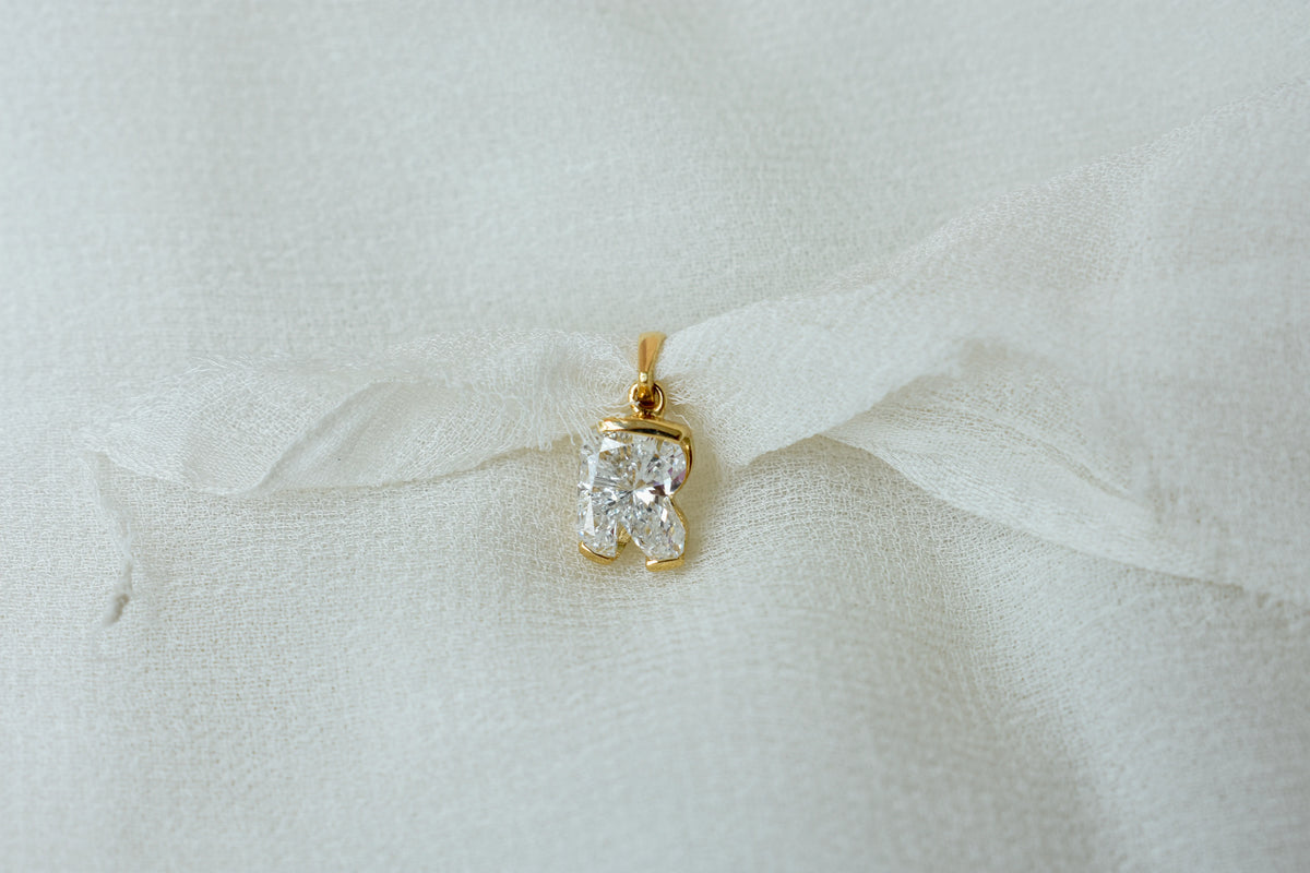 18K gold pendant with lab-grown diamond cut into the letter R