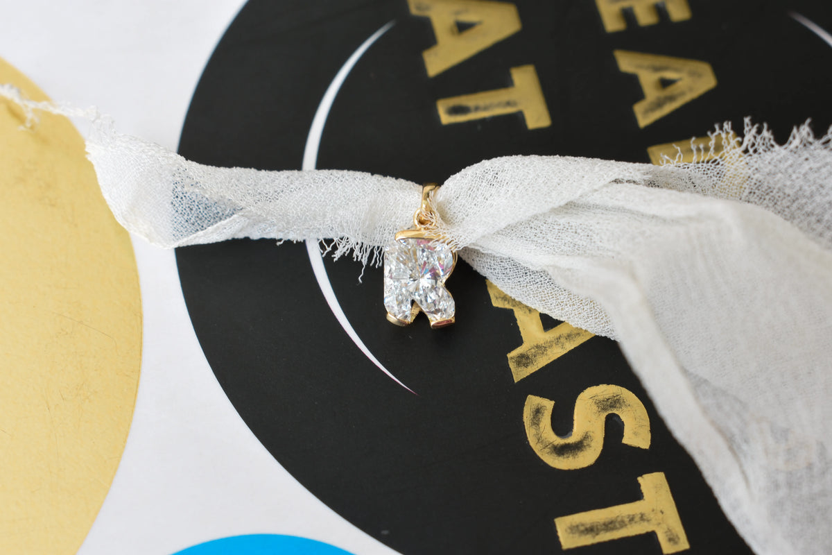 18K gold pendant with lab-grown diamond cut into the letter R