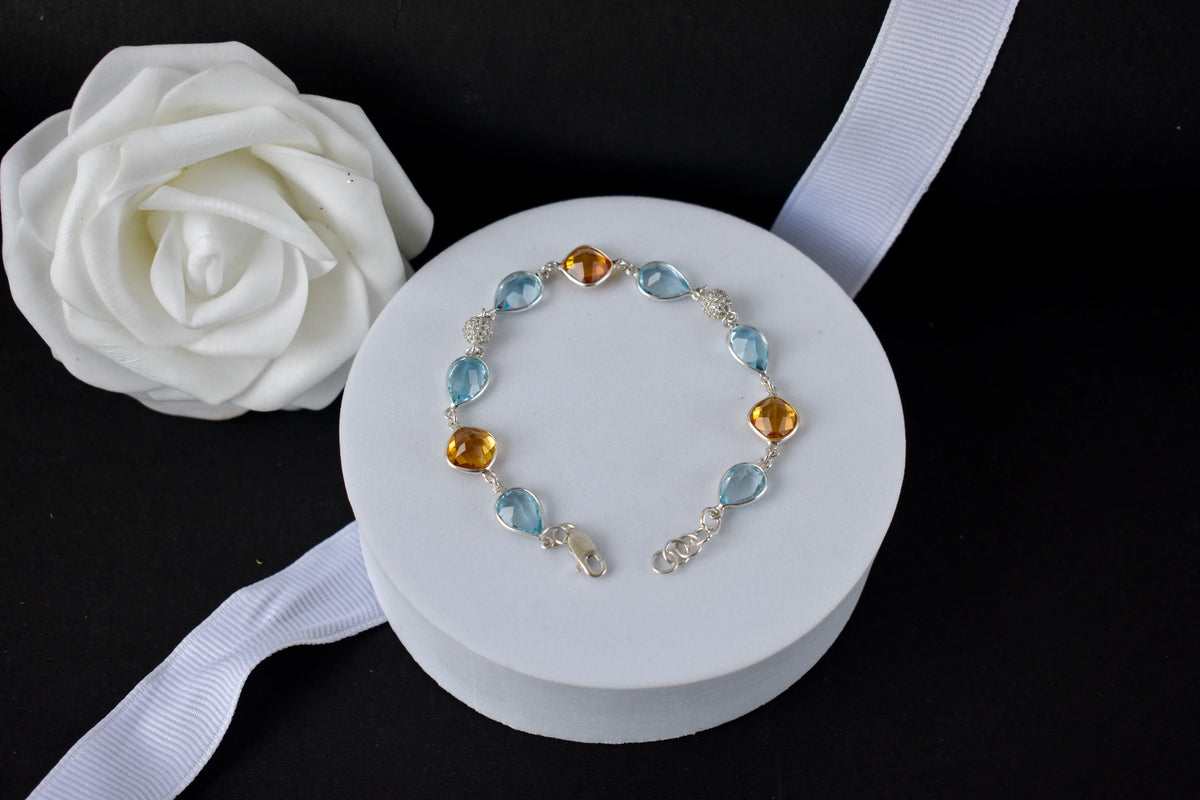 Citrine and blue topaz dangle bracelet with cubic zirconia accents in 925 silver