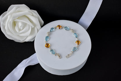 Citrine and blue topaz dangle bracelet with cubic zirconia accents in 925 silver