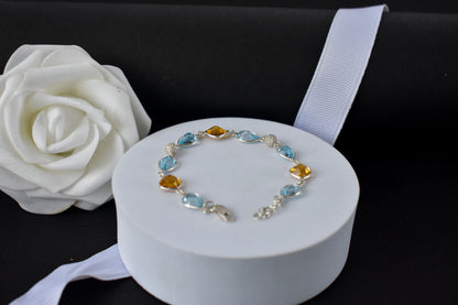 Citrine and blue topaz dangle bracelet with cubic zirconia accents in 925 silver