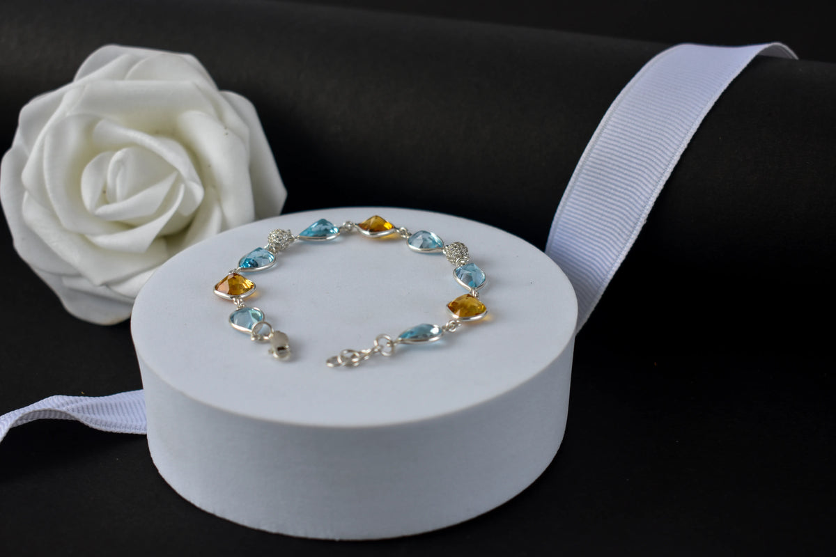 Citrine and blue topaz dangle bracelet with cubic zirconia accents in 925 silver