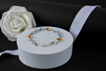 Citrine and blue topaz dangle bracelet with cubic zirconia accents in 925 silver