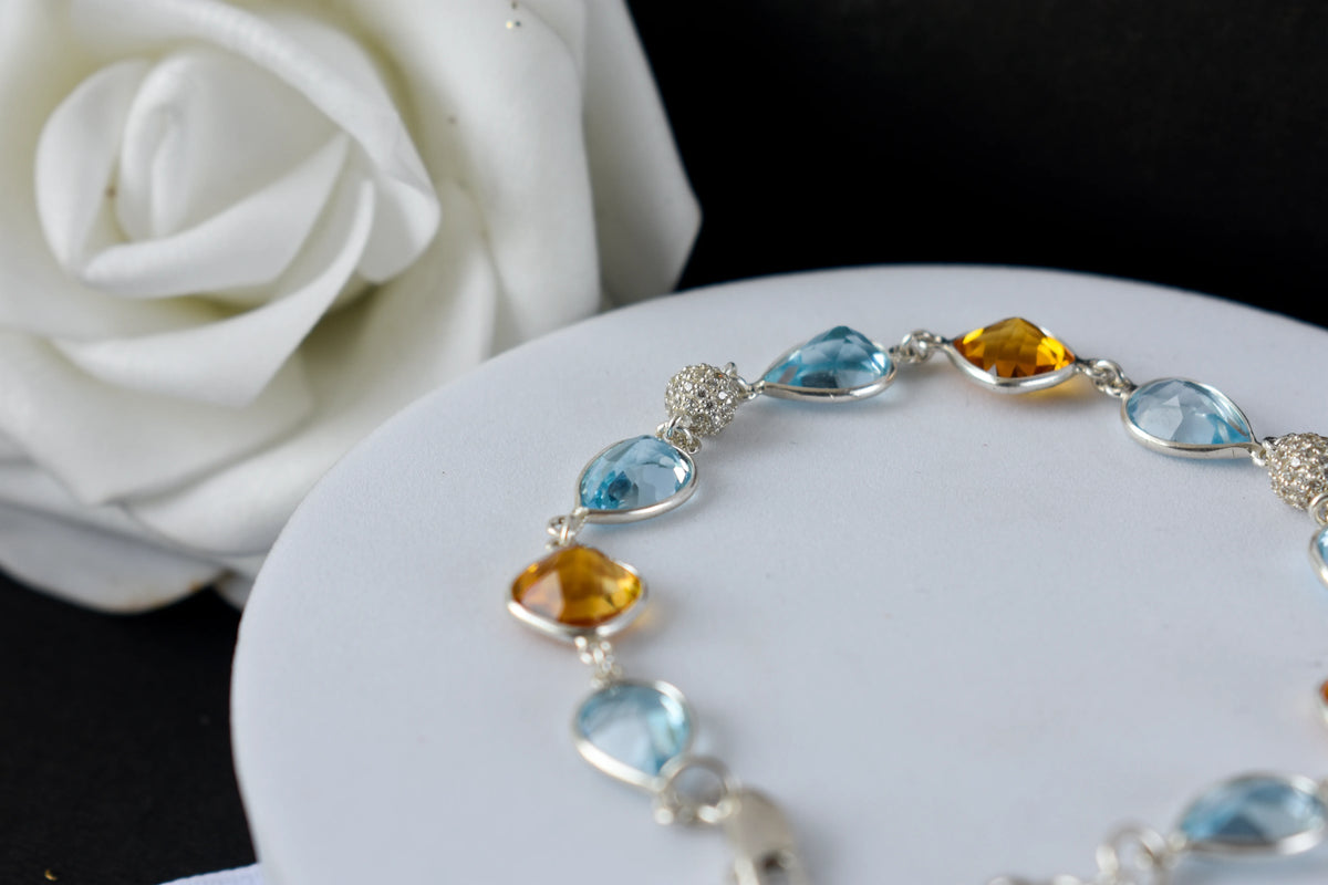 Citrine and blue topaz dangle bracelet with cubic zirconia accents in 925 silver