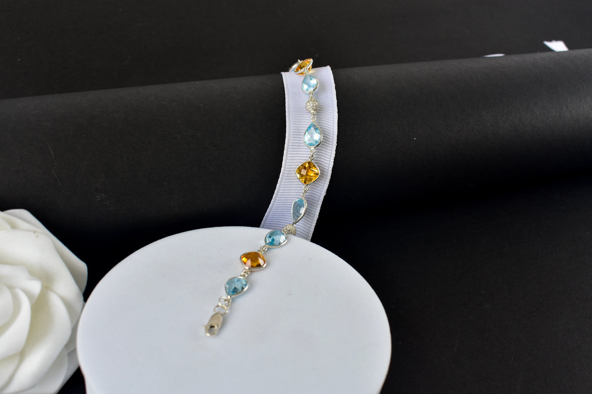 Citrine and blue topaz dangle bracelet with cubic zirconia accents in 925 silver