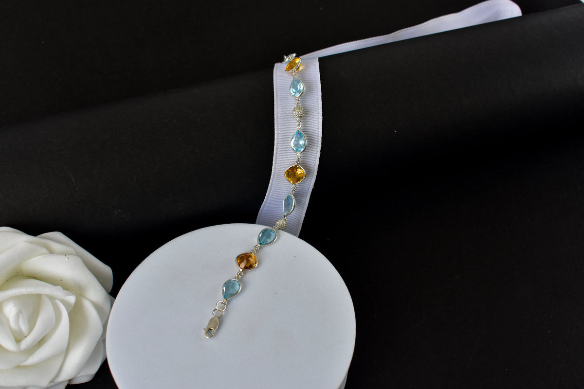Citrine and blue topaz dangle bracelet with cubic zirconia accents in 925 silver