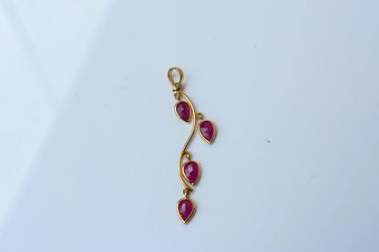 18K gold pendant with four bezel-set pear rubies on a vine design