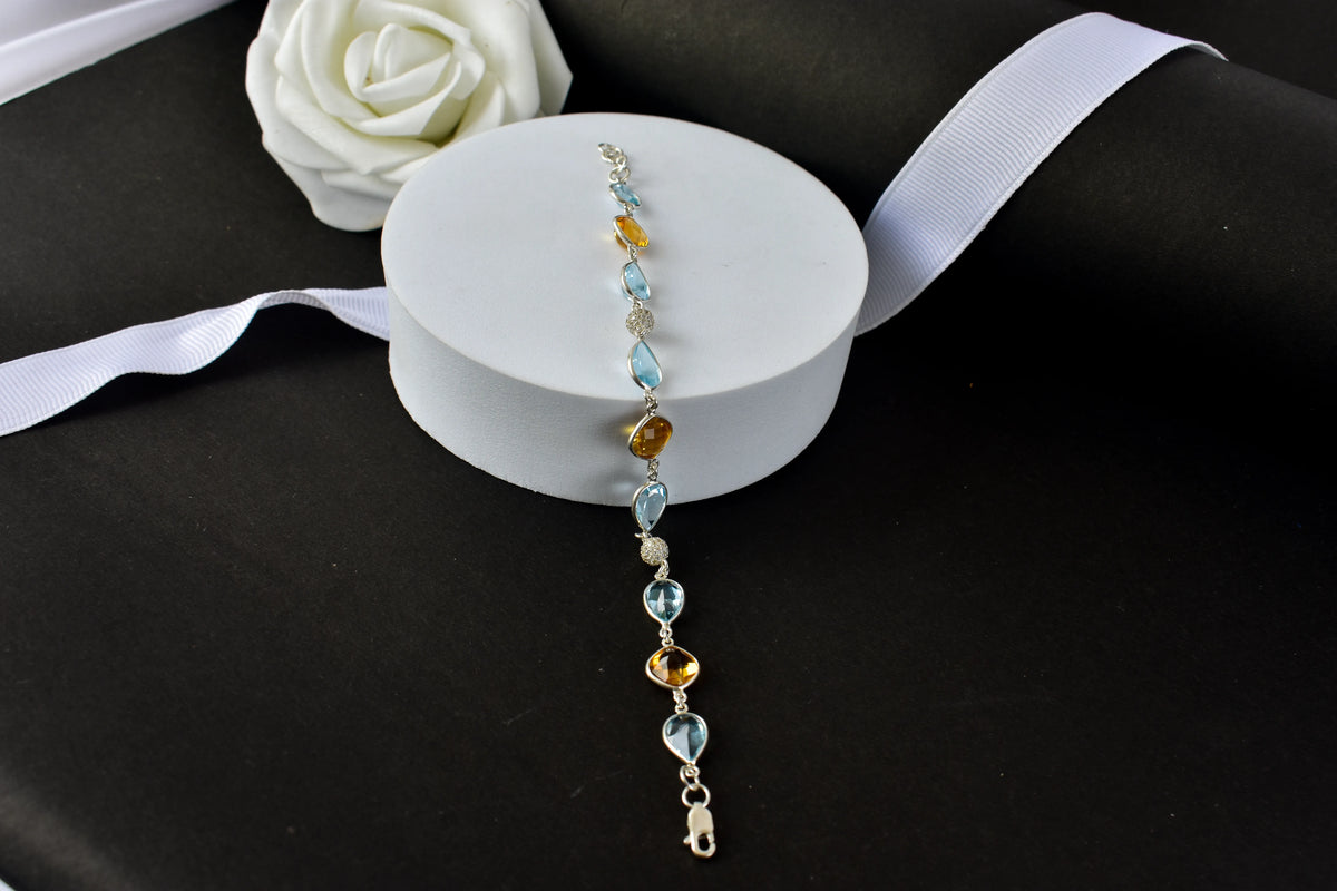 Citrine and blue topaz dangle bracelet with cubic zirconia accents in 925 silver