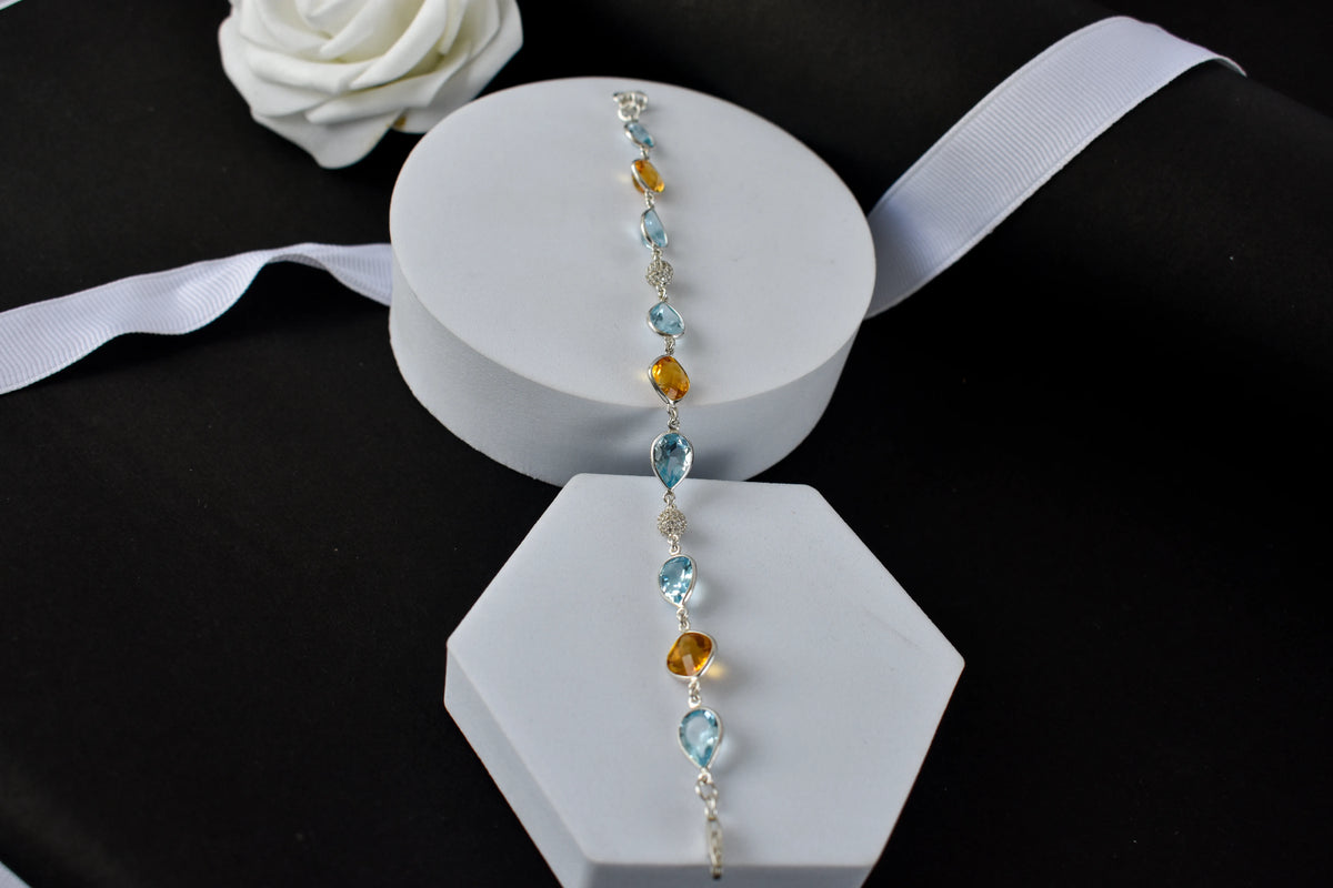 Citrine and blue topaz dangle bracelet with cubic zirconia accents in 925 silver