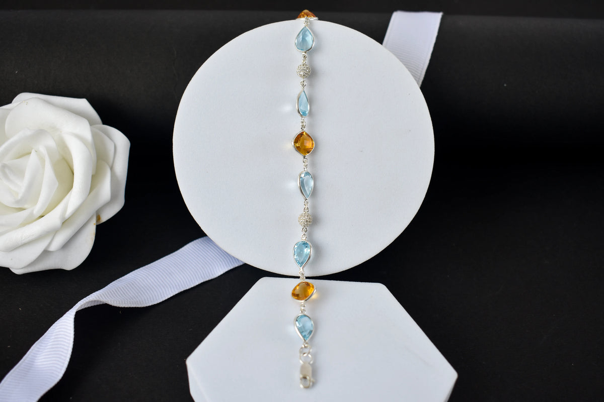 Citrine and blue topaz dangle bracelet with cubic zirconia accents in 925 silver