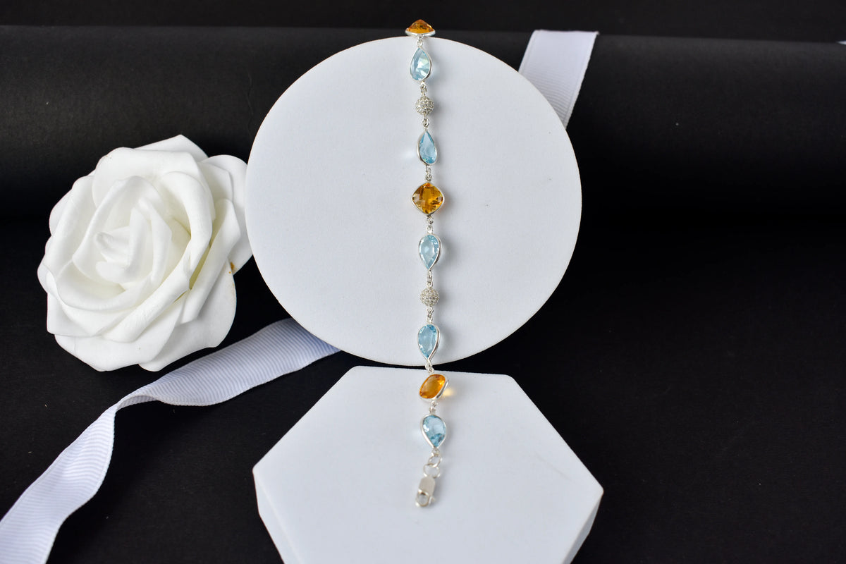 Citrine and blue topaz dangle bracelet with cubic zirconia accents in 925 silver