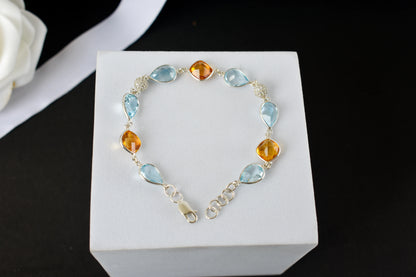 Citrine and blue topaz dangle bracelet with cubic zirconia accents in 925 silver