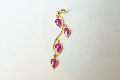18K gold pendant with four bezel-set pear rubies on a vine design