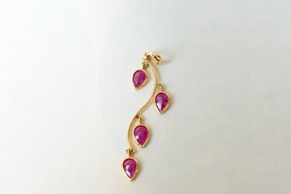 18K gold pendant with four bezel-set pear rubies on a vine design