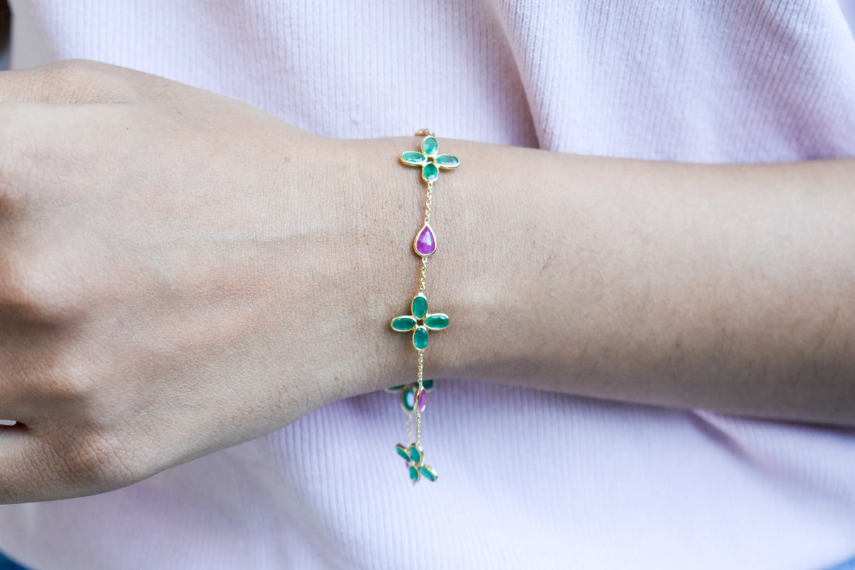 18K gold bracelet with emerald quatrefoil clusters and ruby drops