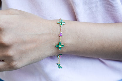 18K gold bracelet with emerald quatrefoil clusters and ruby drops
