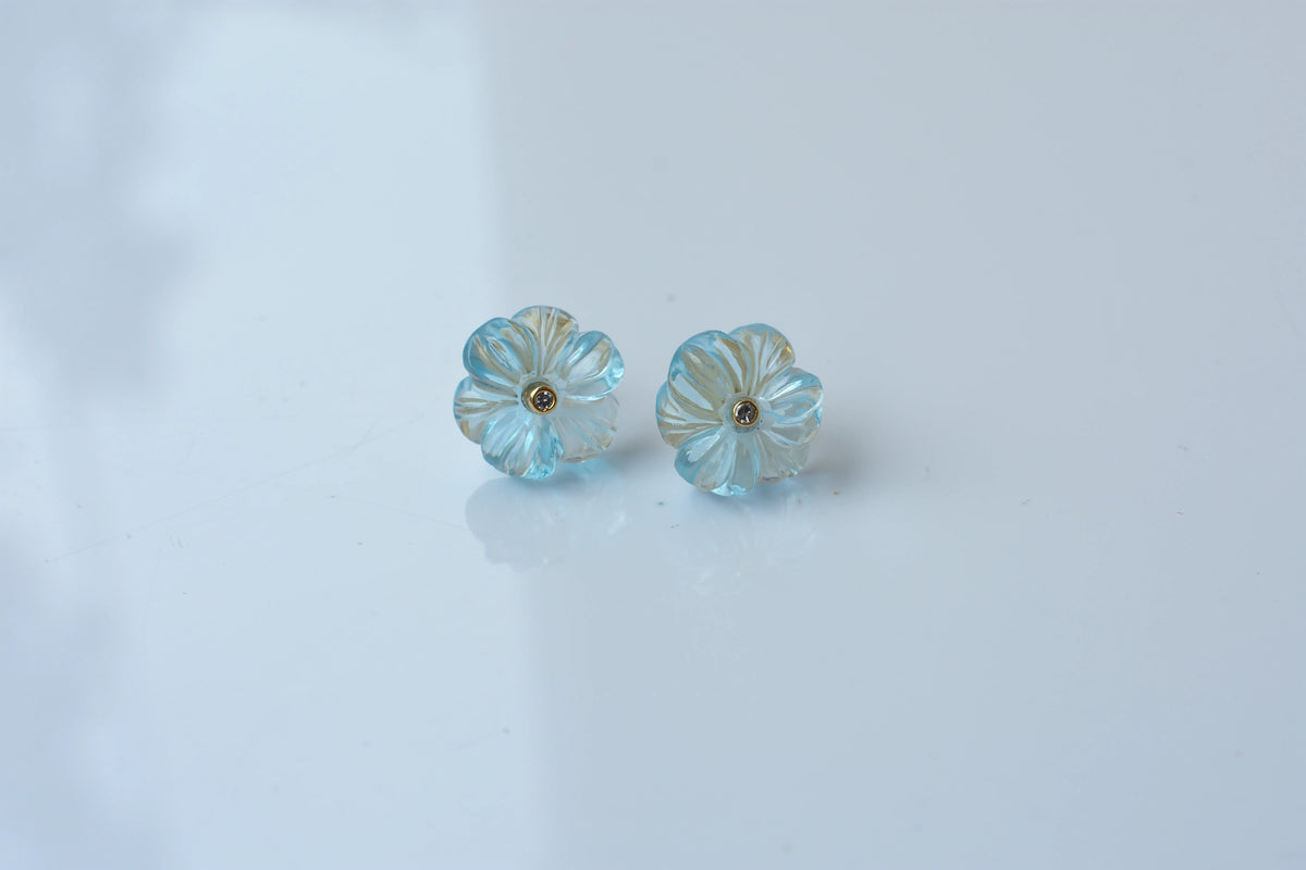 Carved blue topaz flower stud earrings with diamond centre