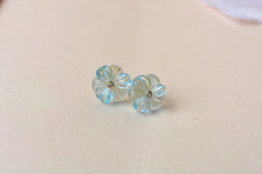 Carved blue topaz flower stud earrings with diamond centre
