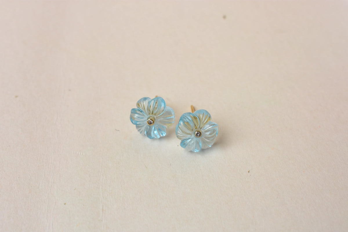 Carved blue topaz flower stud earrings with diamond centre