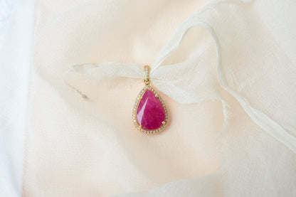 18K gold pendant with large rose-cut pear ruby and diamond halo