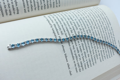 Swiss Blue Topaz tennis bracelet in 925 silver with cubic zirconia