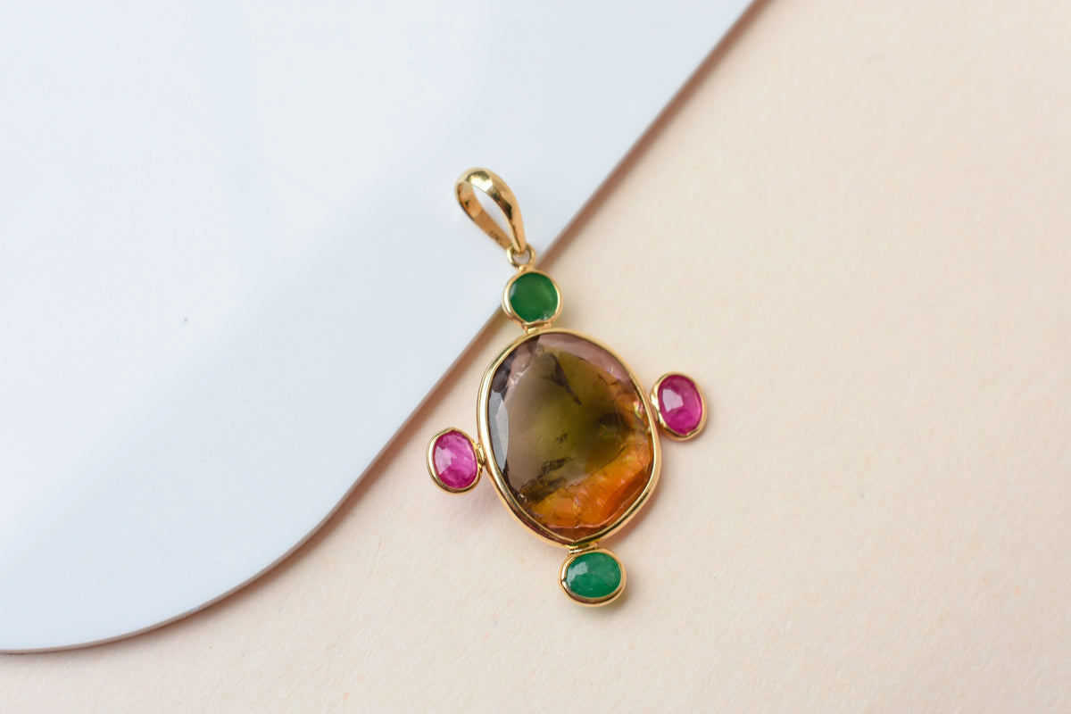 18K gold cross pendant with tourmaline, ruby, and emerald