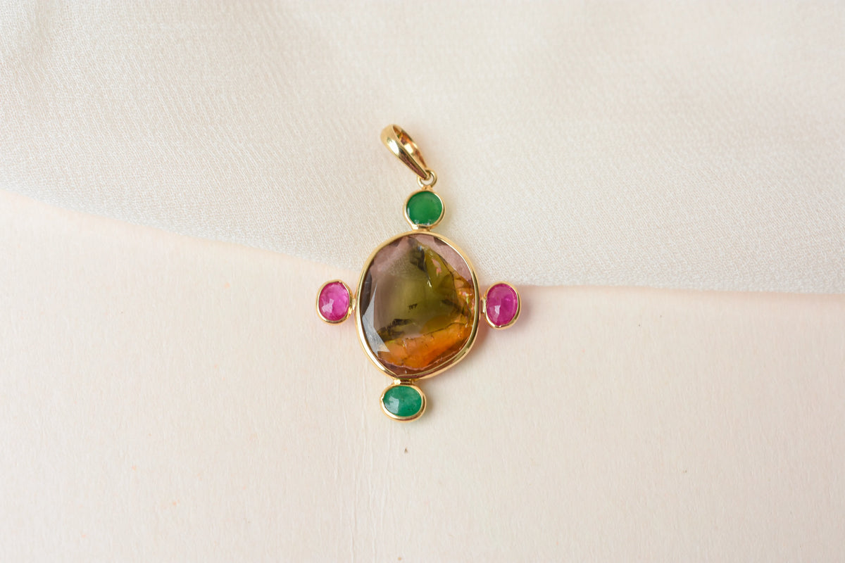 18K gold cross pendant with tourmaline, ruby, and emerald