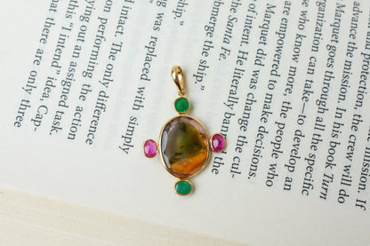 18K gold cross pendant with tourmaline, ruby, and emerald