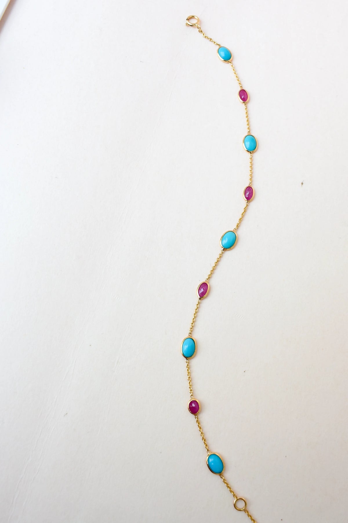 18K gold bracelet with turquoise and ruby stations