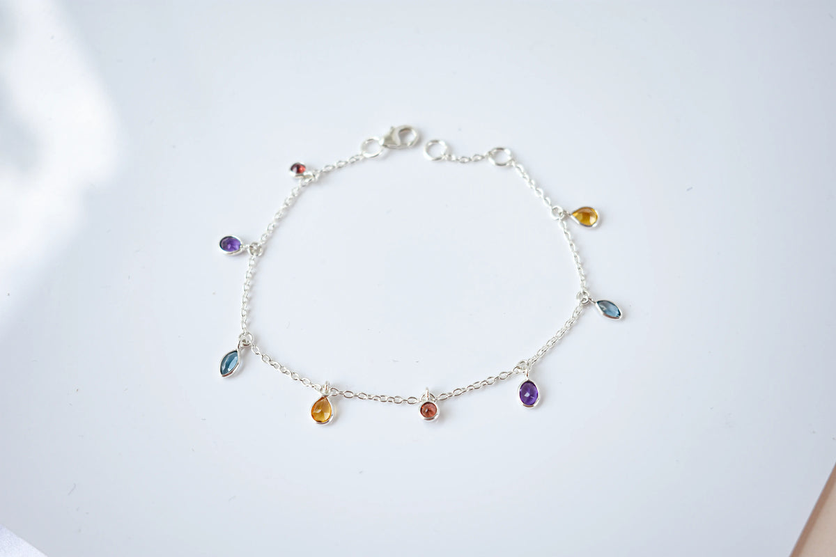 Multi gemstone dangle bracelet with pear-cut colored stones on a 925 silver chain